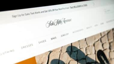 saks fifth avenue online store displaying luxury fashion items and categories on a monitor