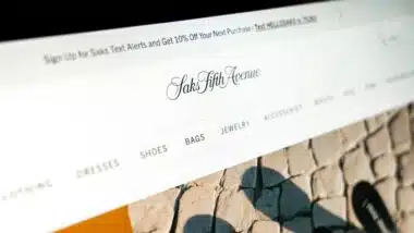 saks fifth avenue online store displaying luxury fashion items and categories on a monitor