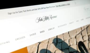 saks fifth avenue online store displaying luxury fashion items and categories on a monitor
