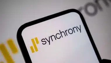 Close up view of mobile device screen presenting the yellow and black Synchrony brand logo