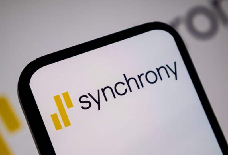 Close up view of mobile device screen presenting the yellow and black Synchrony brand logo