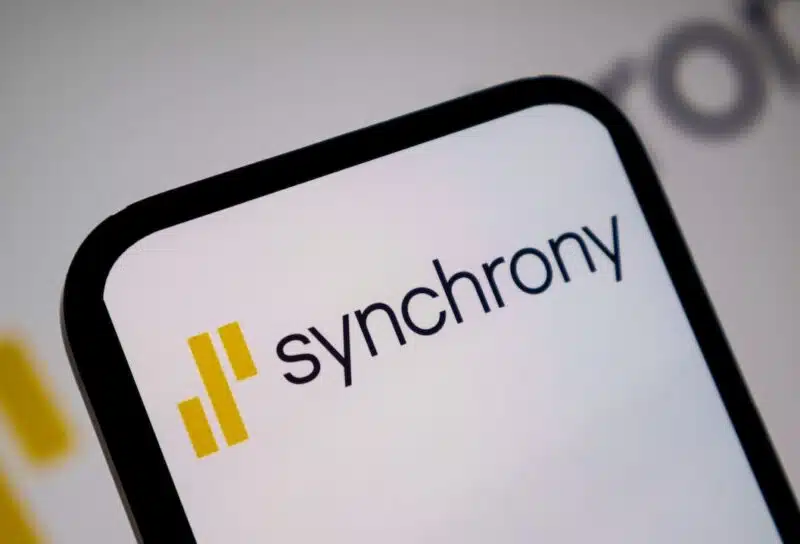 Close up view of mobile device screen presenting the yellow and black Synchrony brand logo