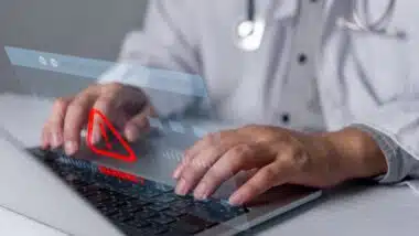 Healthcare cybersecurity warning on laptop represents medical data security