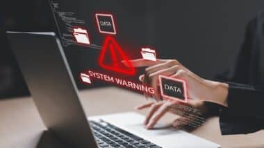 Cybersecurity concept showing system warning on laptop screen.