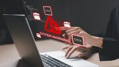 Cybersecurity concept showing system warning on laptop screen.