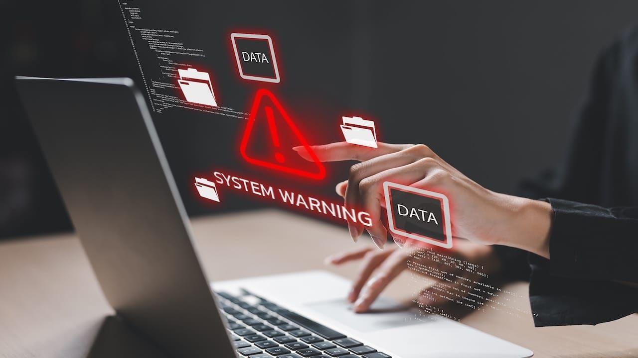 Cybersecurity concept showing system warning on laptop screen.