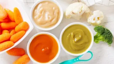 Baby food. Various kinds of bowls of fruit and vegetable puree with fresh vegetables, top view