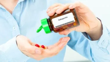 Gabapentin Woman Hand holding on open palm with pill tablets medicine for healing