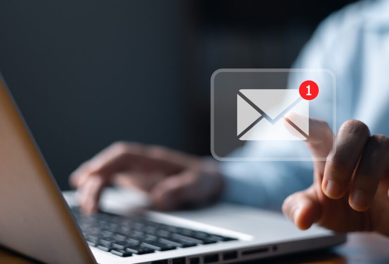 Email marketing concept, person reading e-mail on laptop computer