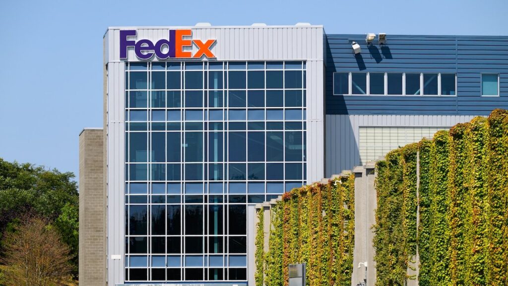 FedEx building with name on structure in company colors and ivy wall