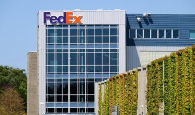 FedEx building with name on structure in company colors and ivy wall