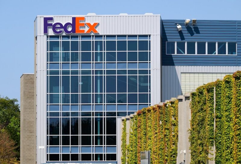 FedEx building with name on structure in company colors and ivy wall