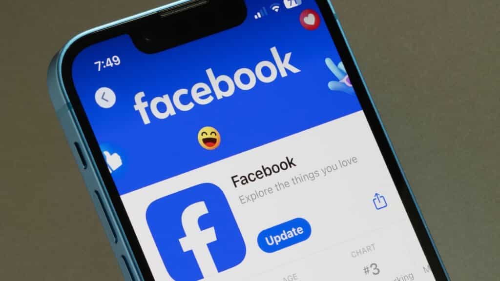 Facebook app is seen in the App Store on an iPhone. Facebook is a social media and social networking service owned by American technology conglomerate Meta