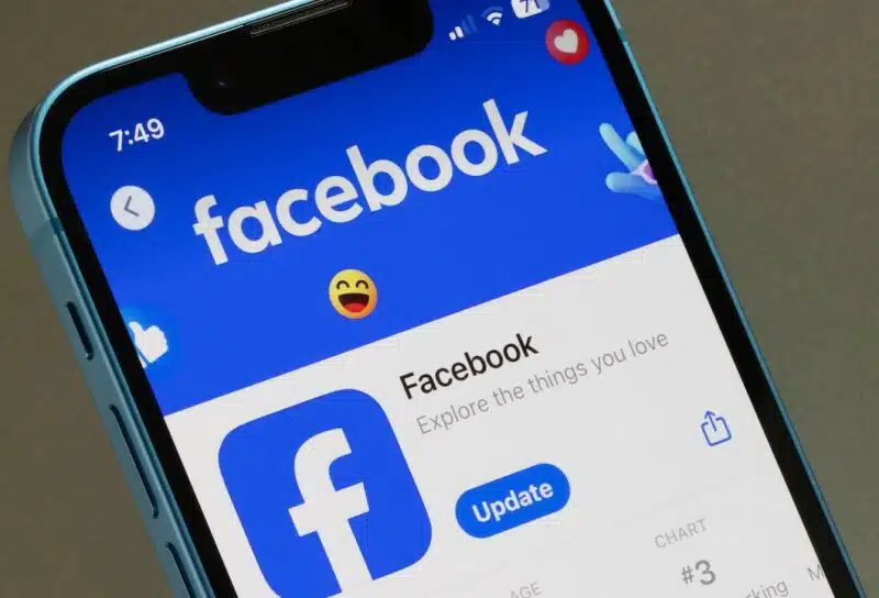 Facebook app is seen in the App Store on an iPhone. Facebook is a social media and social networking service owned by American technology conglomerate Meta