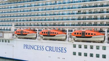 Side view of the cruise ship Sky Princess and lifeboats with the logo of Princess Cruises on its hull.
