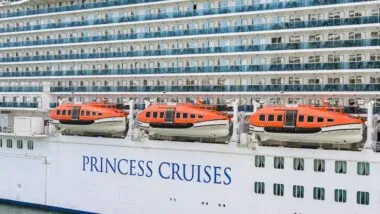 Side view of the cruise ship Sky Princess and lifeboats with the logo of Princess Cruises on its hull.